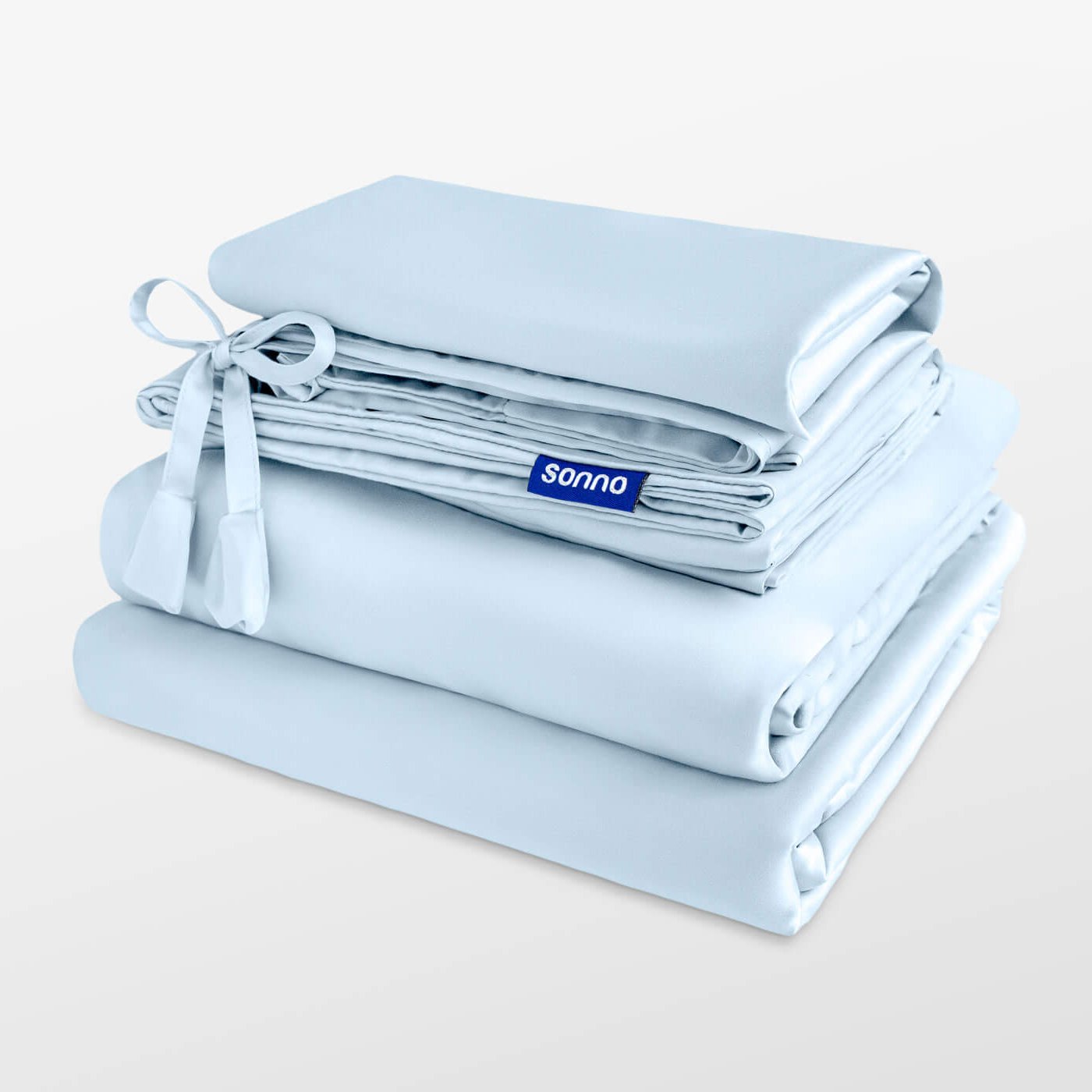 Folded light blue bedding set with 'sonno' branding on a white background