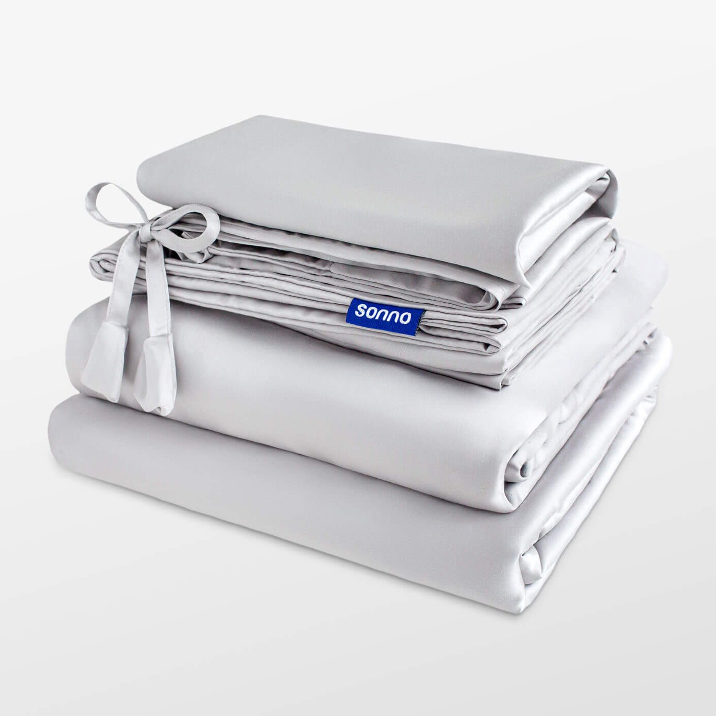 Folded gray bedding set with 'sonno' branding on a white background