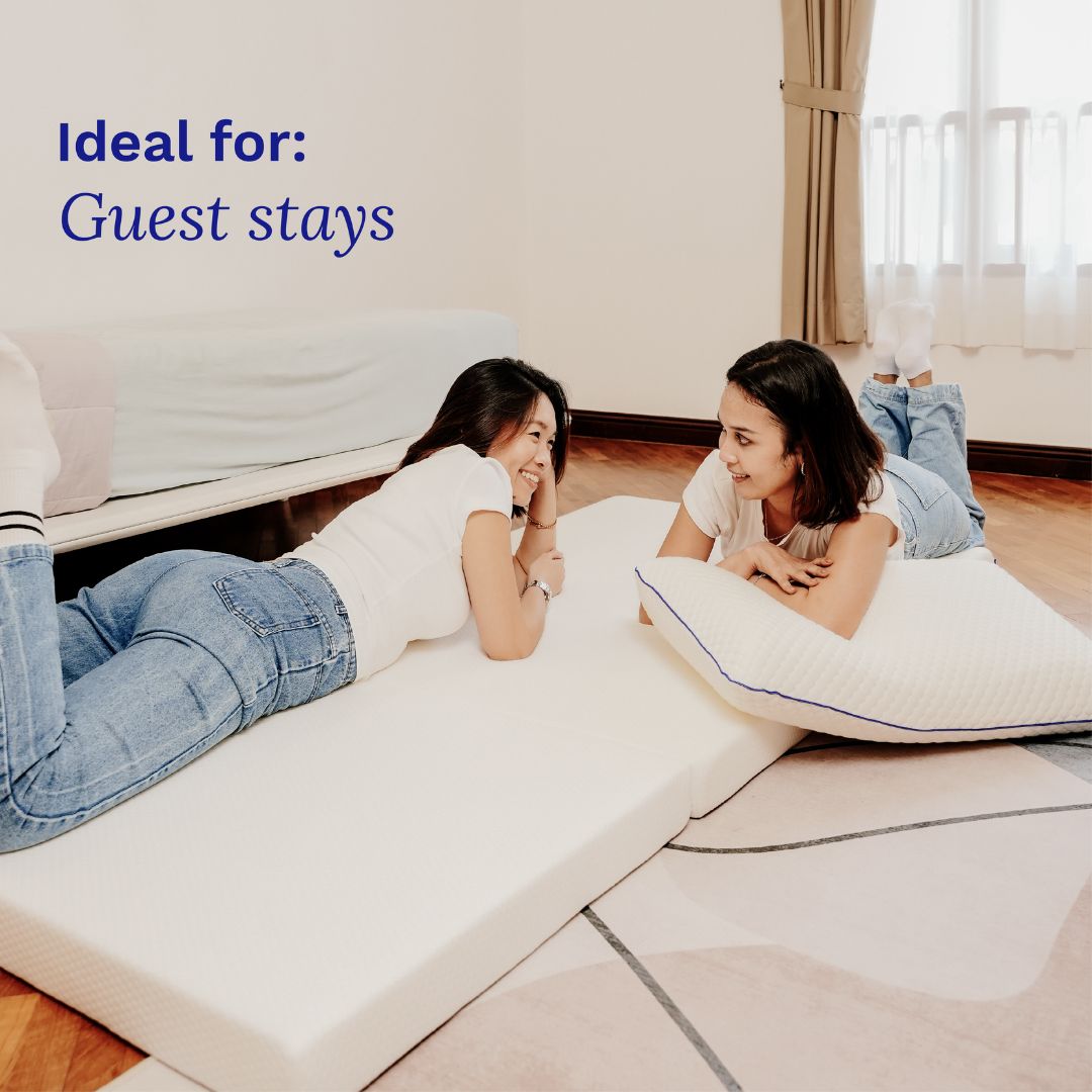 Two women lying on inflatable mattresses in a room with 'Ideal for: Guest stays' text.