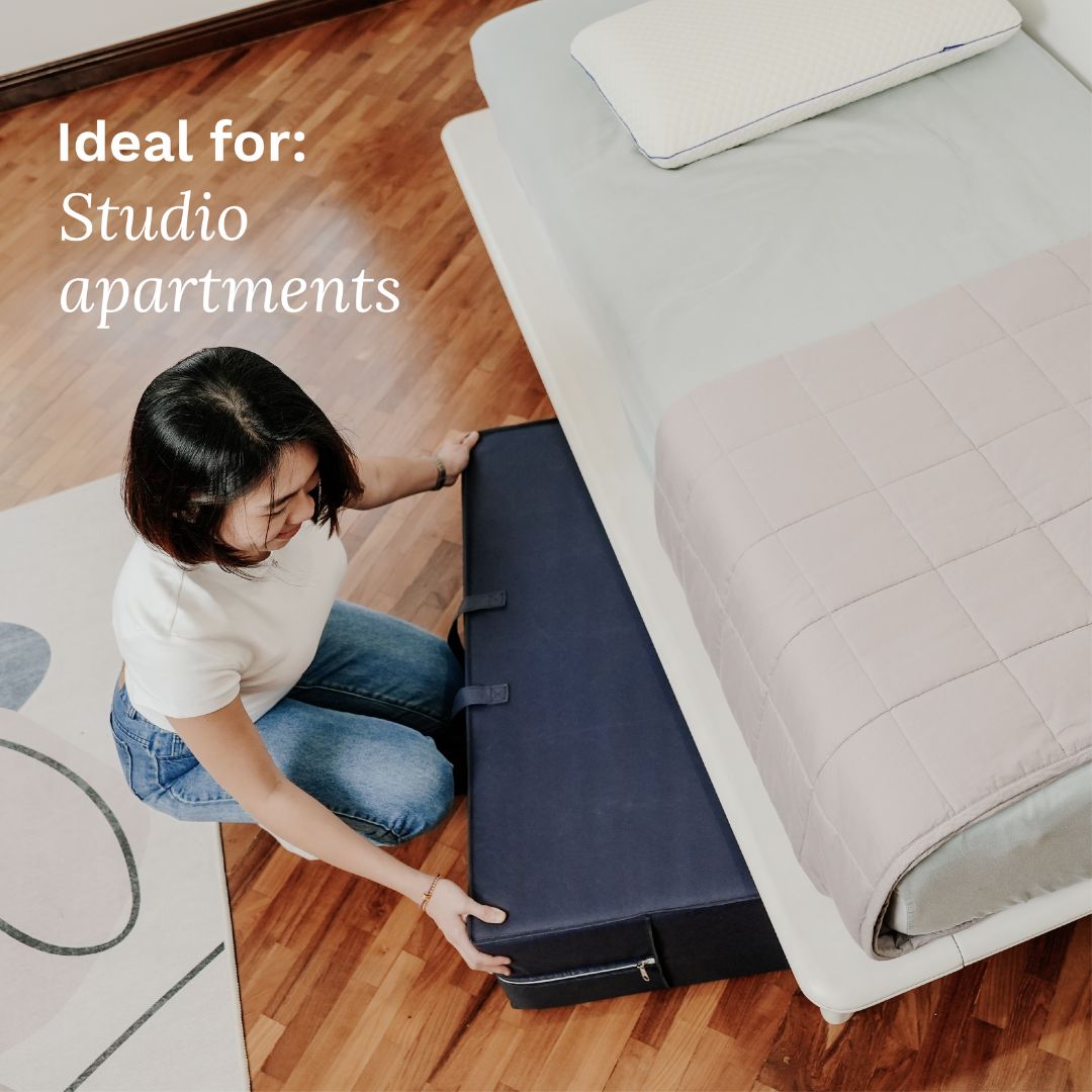 Person setting up a compact bed in a small living space with text 'Ideal for: Studio apartments'.