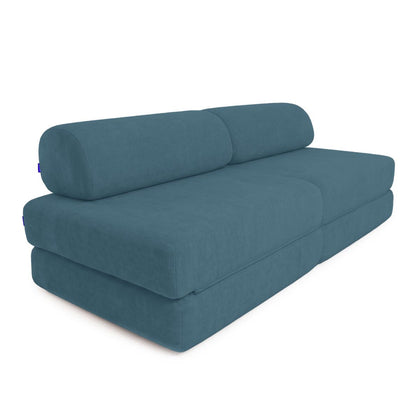 A modern two-seater sofa bed in a textured slate blue fabric, shown from a three-quarters perspective against a plain white background.