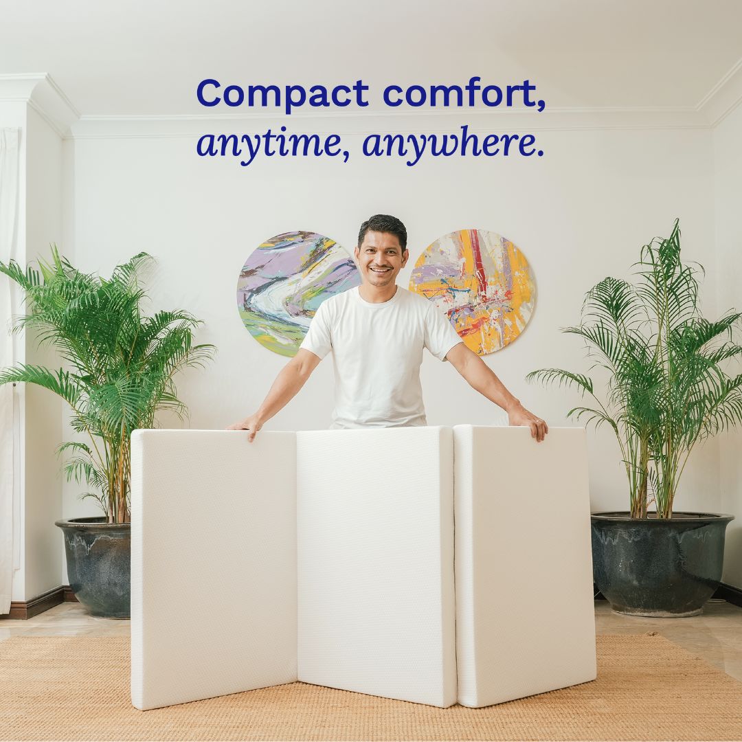 Man standing behind a modular seating system with plants and abstract art in the background.