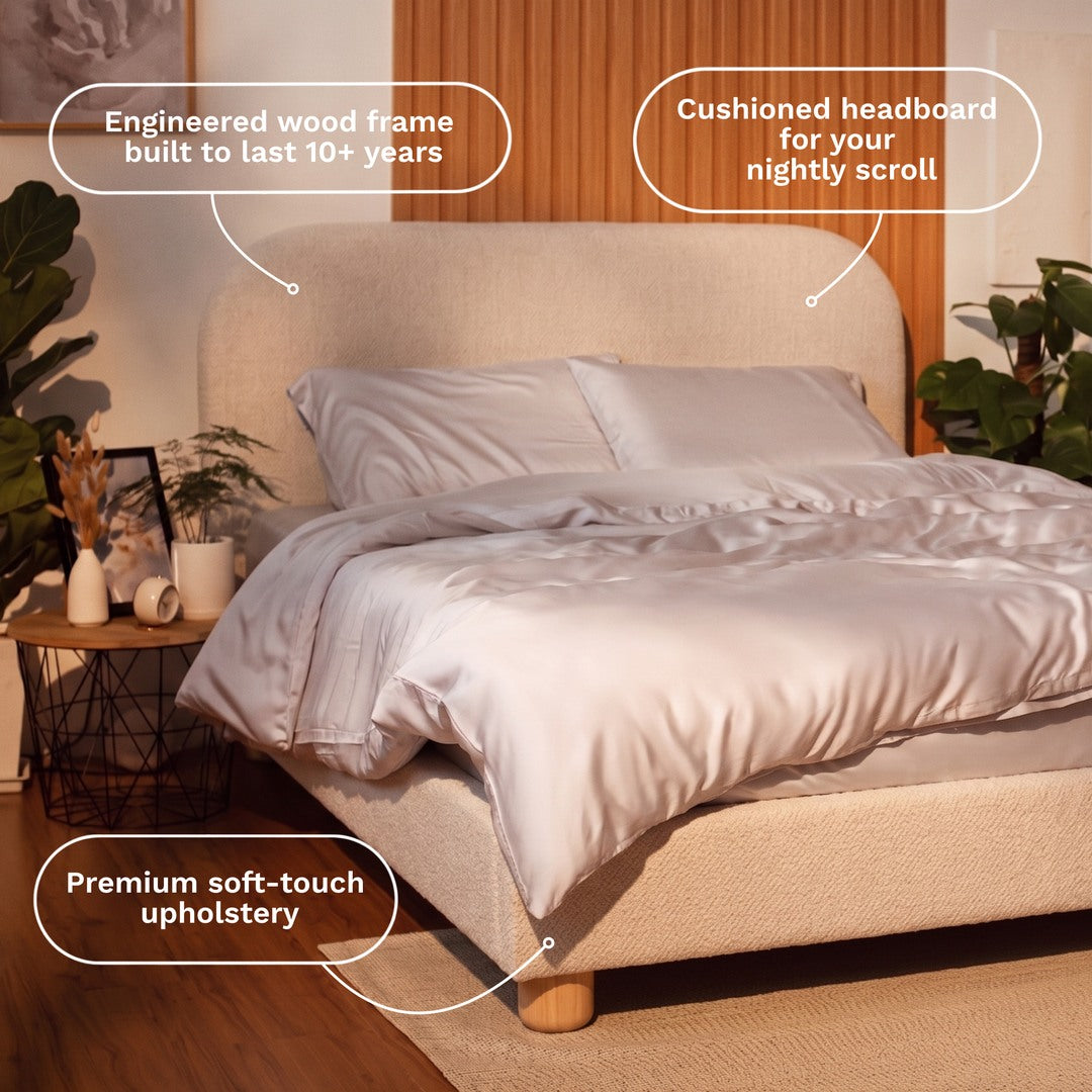Beige upholstered Sonno Sunset bed frame with cushioned headboard and engineered wood frame in a bedroom setting.
