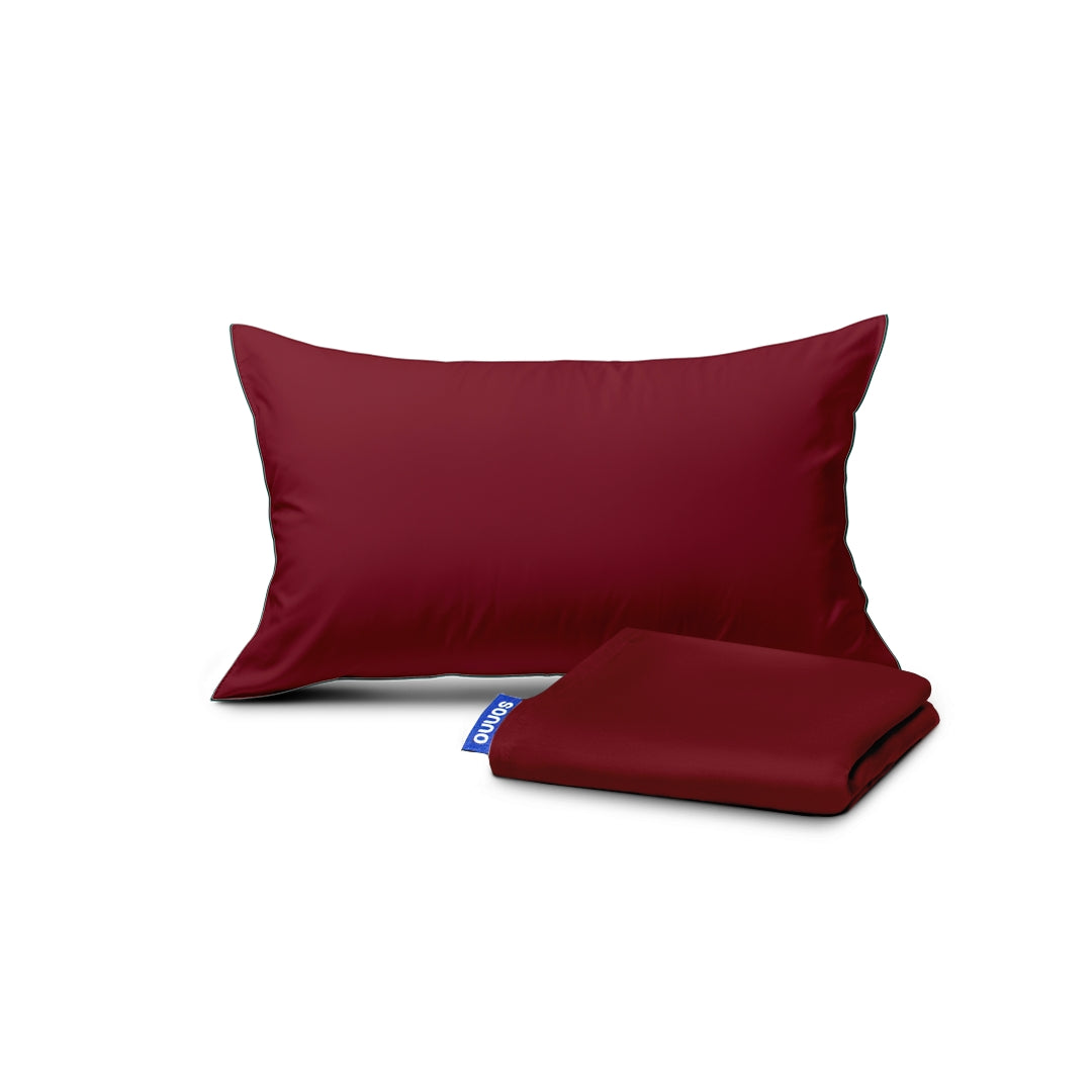 Red pillowcase and red blanket with a brand logo on a white background