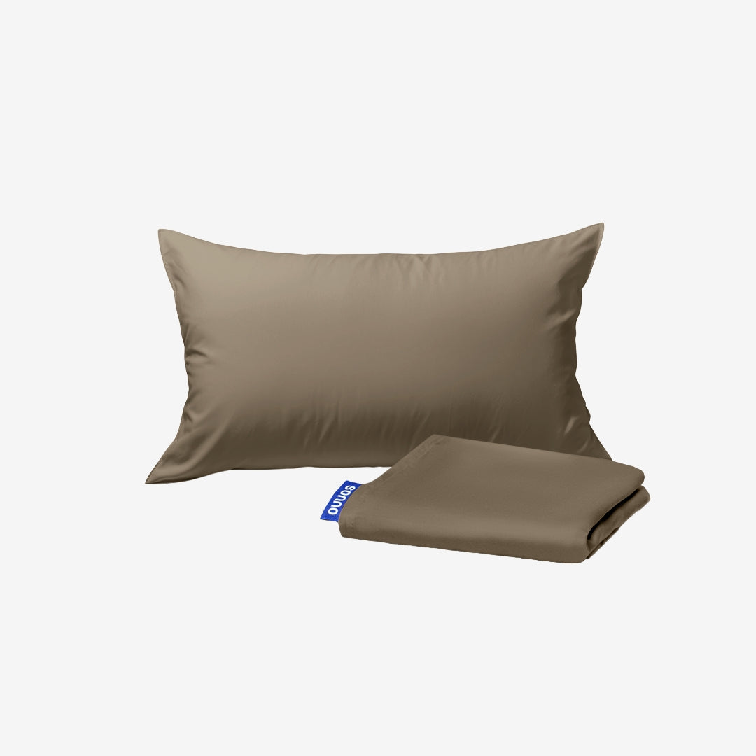 Brown pillow and folded blanket set on a white background