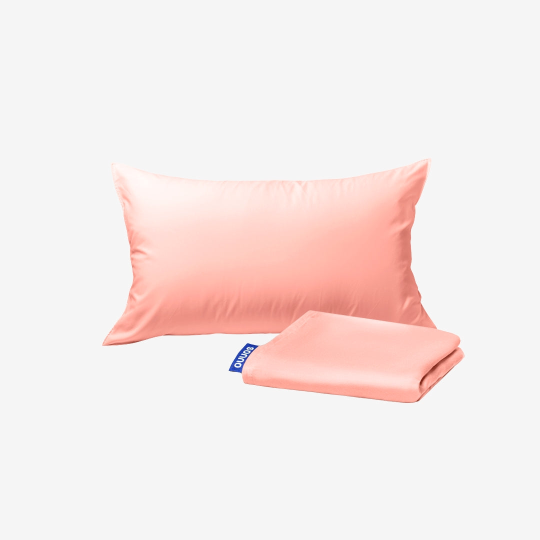 Pink satin pillowcase and matching fabric on a white background