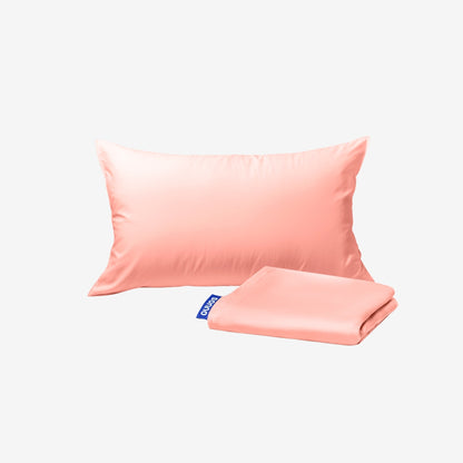 Pink satin pillowcase and matching fabric on a white background