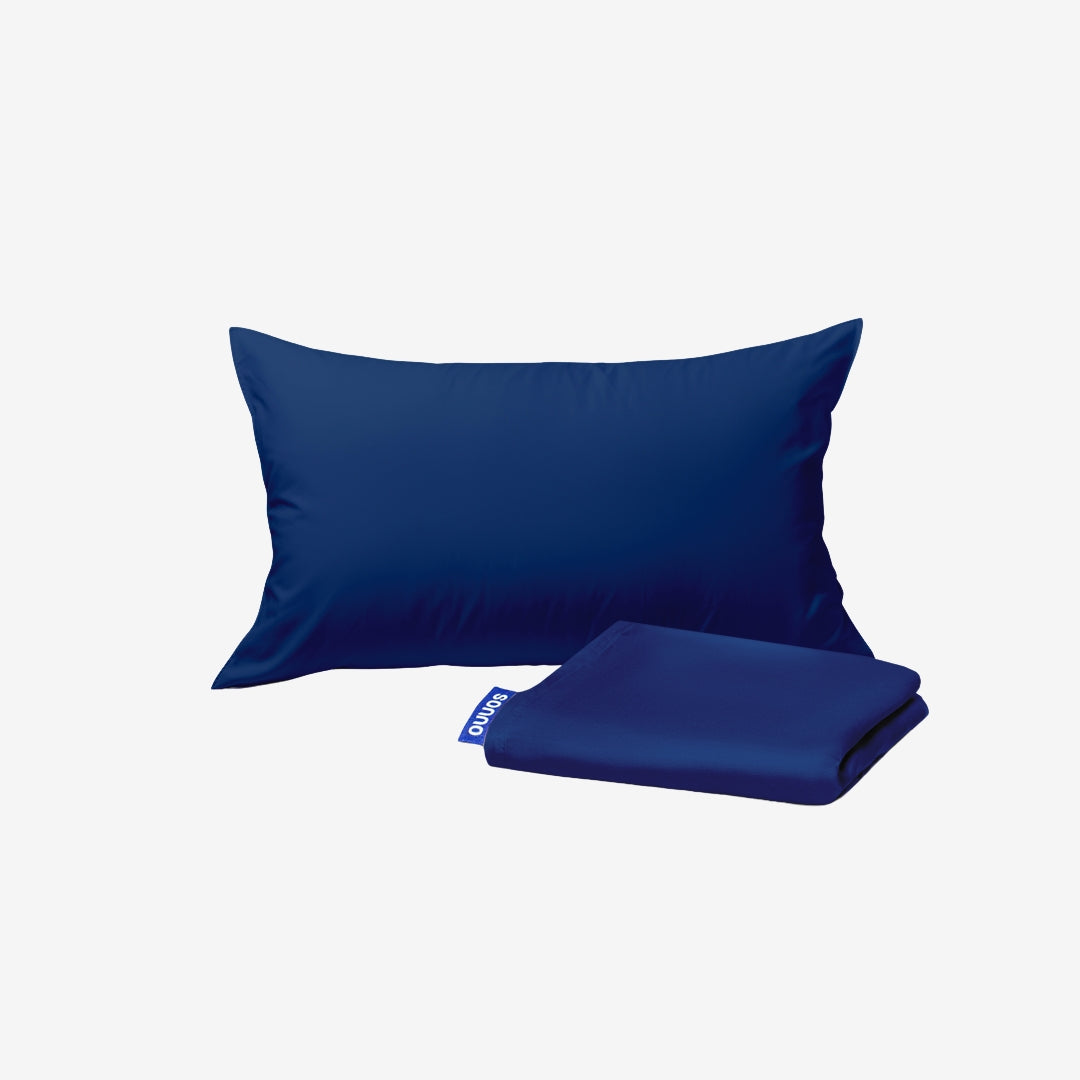 Blue pillow and folded blanket on a white background