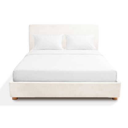 Beige Sonno Sunset Bed frame upholstered bed with white bedding on a white background